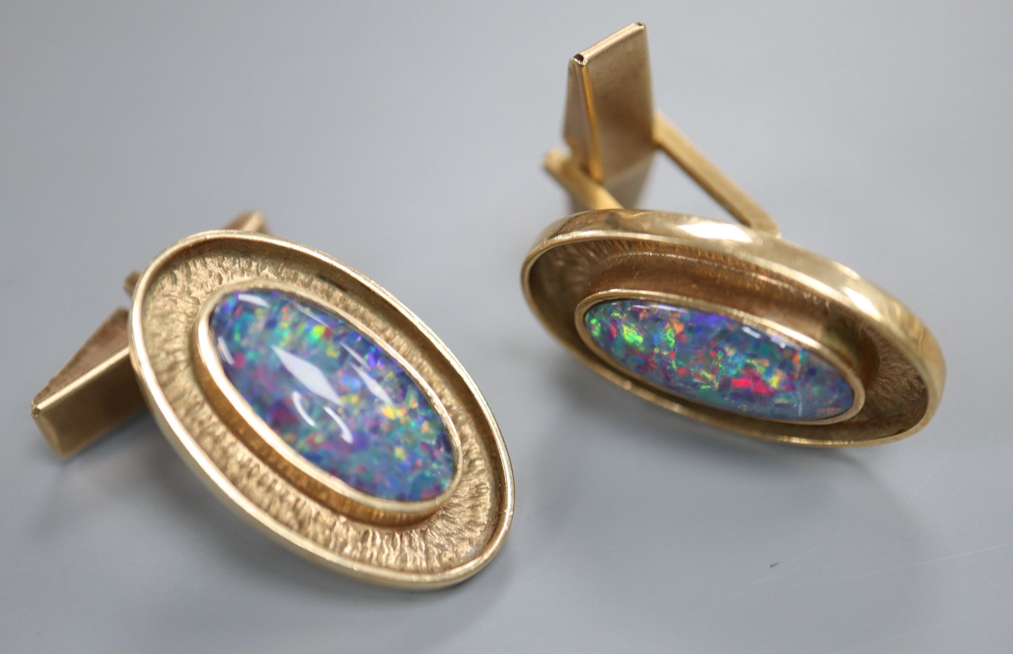 A pair of 9ct gold and opal doublet? set oval cufflinks, 24mm, gross 12.6 grams.